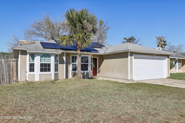 ranch-style house featuring solar panels, a garage, and a front lawn