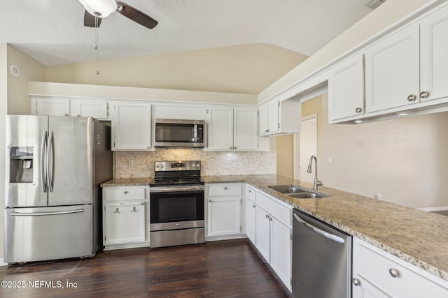 kitchen featuring white cabinetry, sink, lofted ceiling, and stainless steel appliances