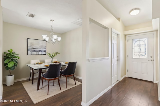 interior space featuring dark wood-type flooring and an inviting chandelier