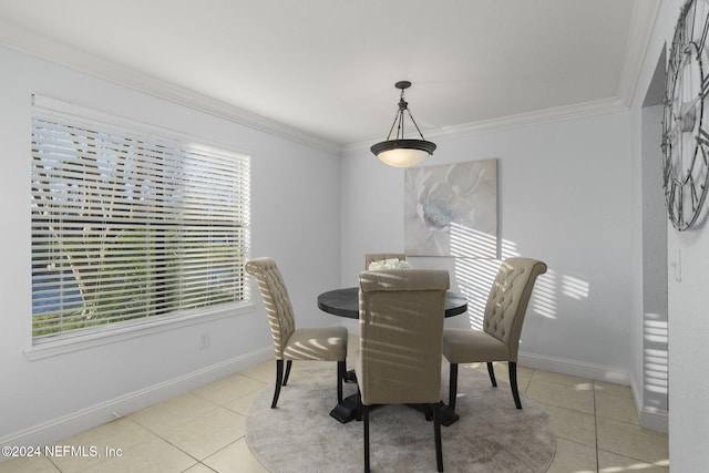 tiled dining room with a healthy amount of sunlight and ornamental molding