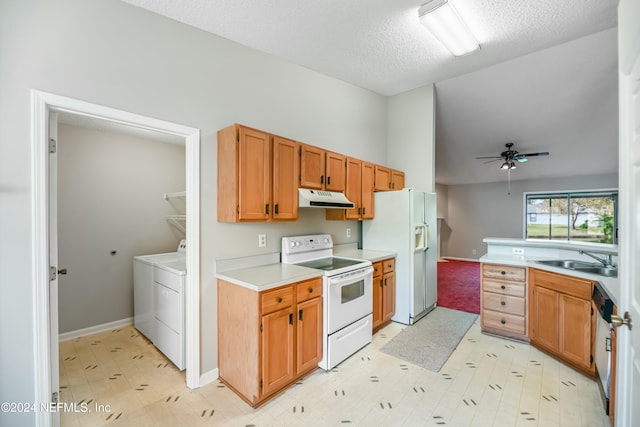 kitchen with ceiling fan, sink, a textured ceiling, white appliances, and washer and dryer