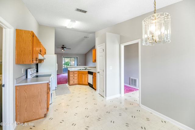 kitchen featuring pendant lighting, dishwasher, lofted ceiling, stainless steel range oven, and kitchen peninsula