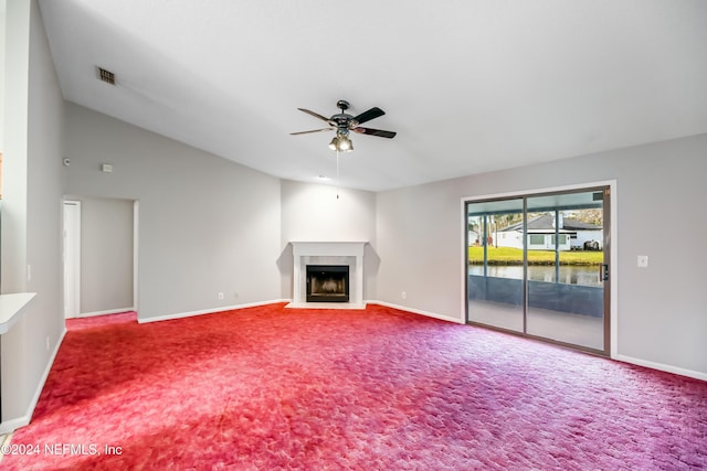 unfurnished living room with carpet, a water view, ceiling fan, and lofted ceiling