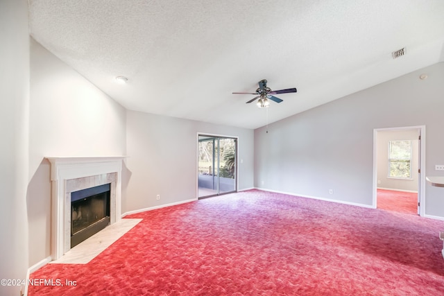 unfurnished living room with ceiling fan, carpet floors, and vaulted ceiling