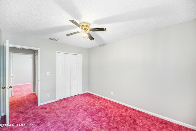 unfurnished bedroom with carpet flooring, ceiling fan, a closet, and a textured ceiling