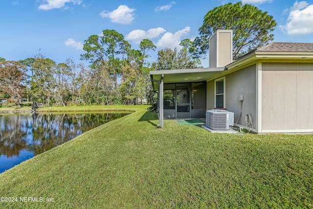 view of yard featuring central air condition unit and a water view