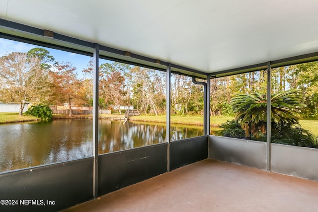 unfurnished sunroom featuring a water view