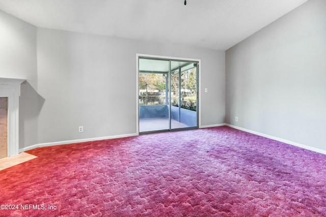 unfurnished living room featuring carpet flooring and lofted ceiling