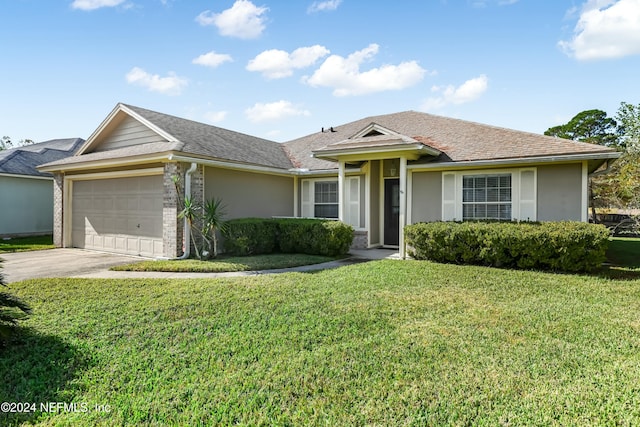 view of front of house featuring a garage and a front lawn