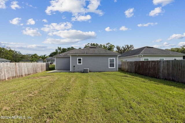 back of house featuring a patio area, cooling unit, and a yard