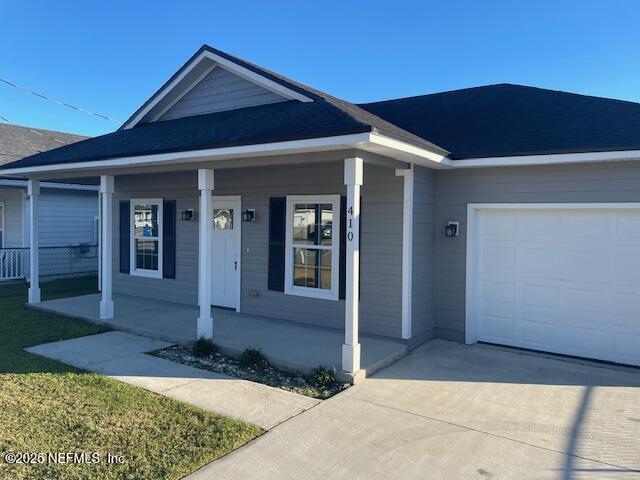 view of front of home featuring a garage and a porch