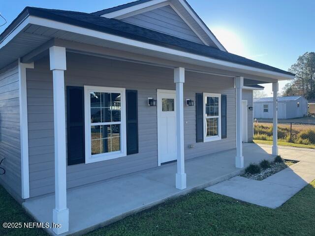 doorway to property with a porch