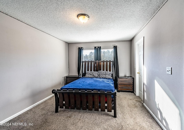 bedroom featuring carpet and a textured ceiling