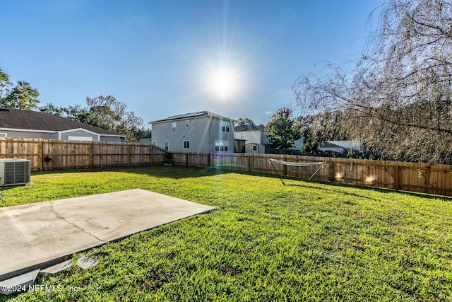 view of yard featuring central air condition unit and a patio