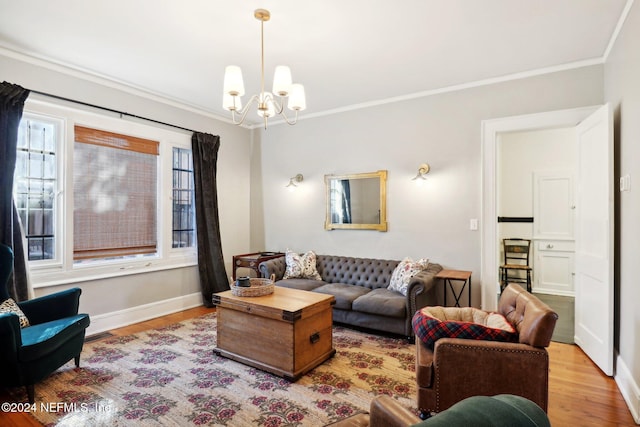 living room with a chandelier, light hardwood / wood-style floors, and crown molding