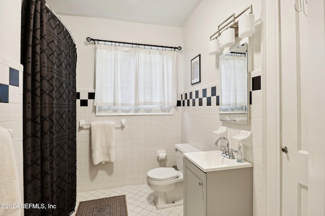 bathroom with tile patterned flooring, vanity, tile walls, and toilet