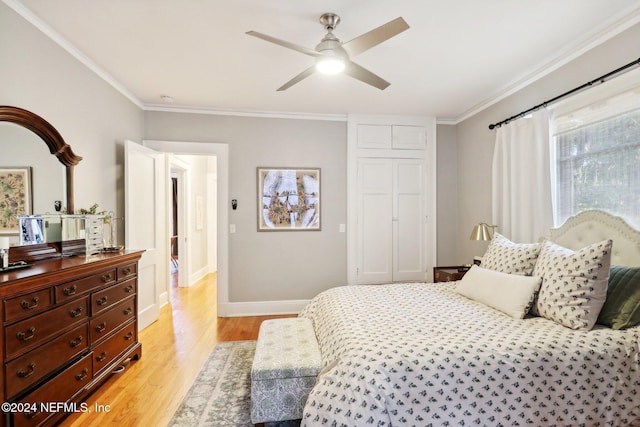 bedroom featuring light wood-type flooring, ceiling fan, and ornamental molding