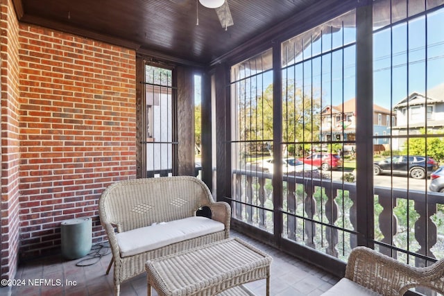 sunroom / solarium featuring wooden ceiling, ceiling fan, and a healthy amount of sunlight