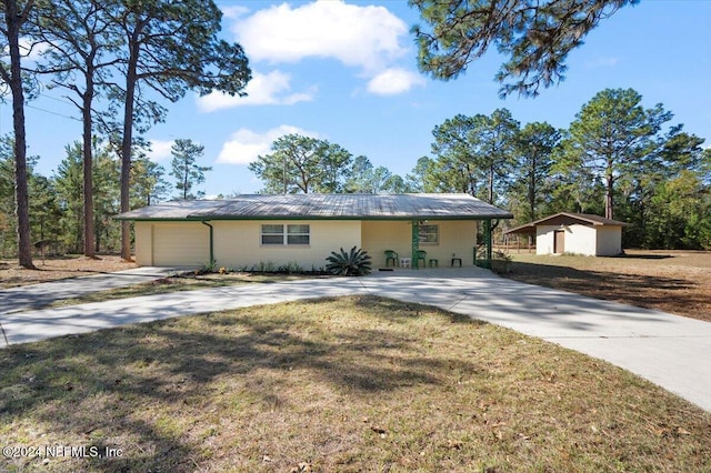 single story home with a shed and a front yard