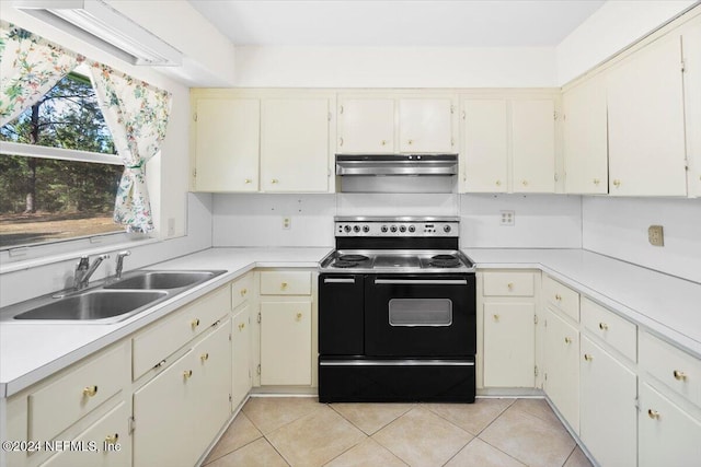 kitchen with electric stove, sink, and light tile patterned flooring