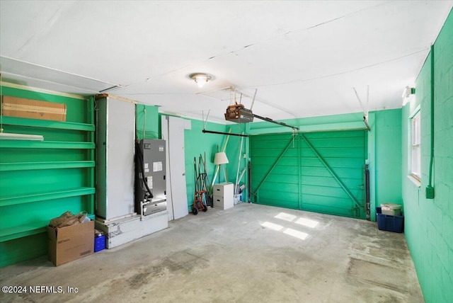 garage featuring heating unit and a garage door opener