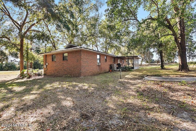 view of side of property with central AC