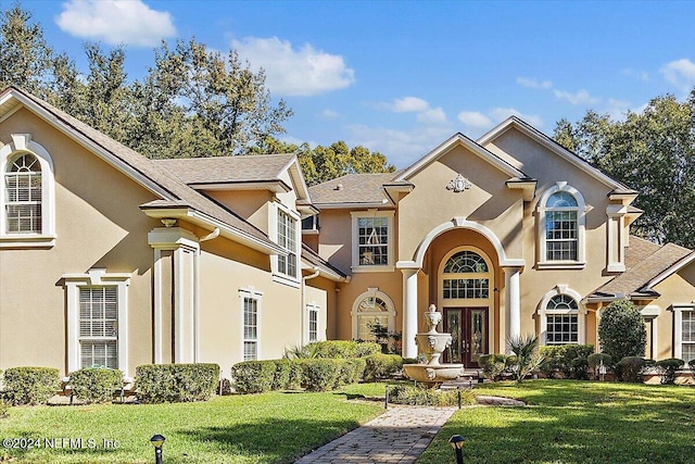 view of front of home featuring a front lawn and french doors