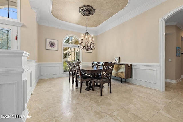 dining room featuring a raised ceiling, a wealth of natural light, and a notable chandelier