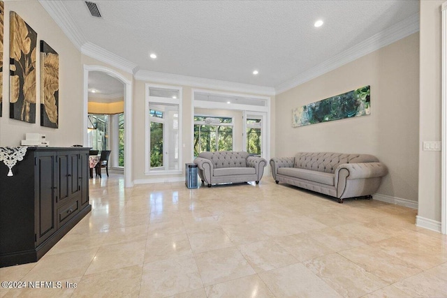 living room featuring crown molding and a textured ceiling