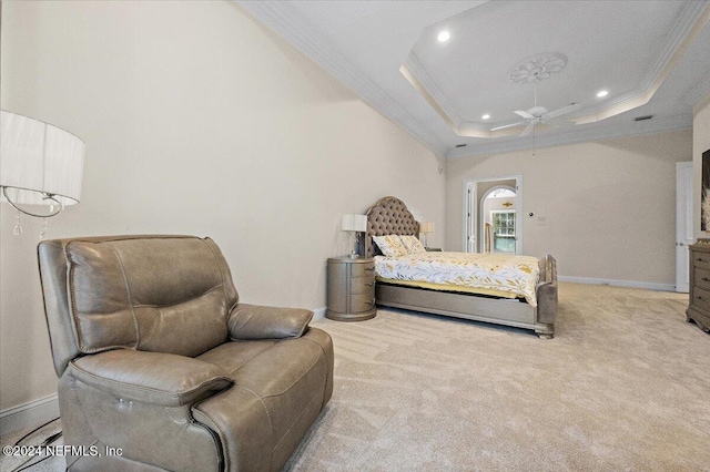 carpeted bedroom featuring ceiling fan, a raised ceiling, and ornamental molding