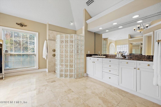 bathroom featuring a textured ceiling and a wealth of natural light