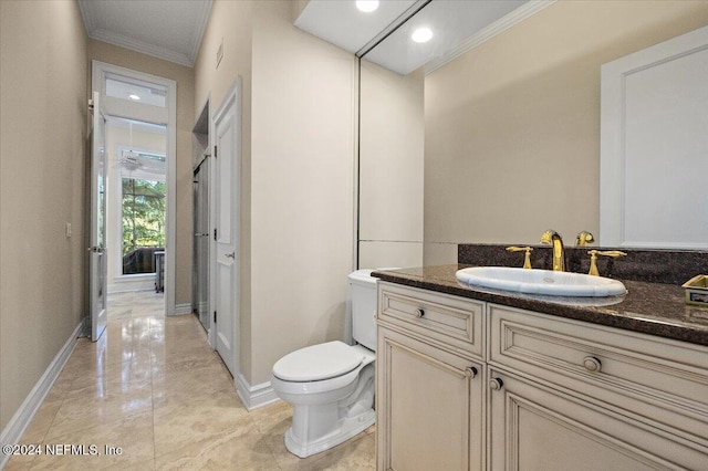 bathroom with vanity, toilet, and crown molding