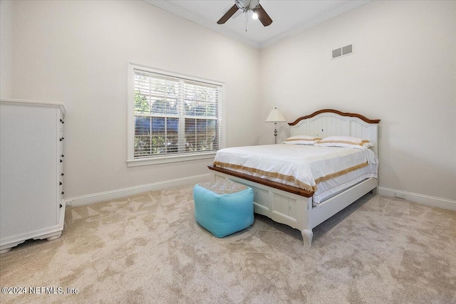 carpeted bedroom with ceiling fan and ornamental molding