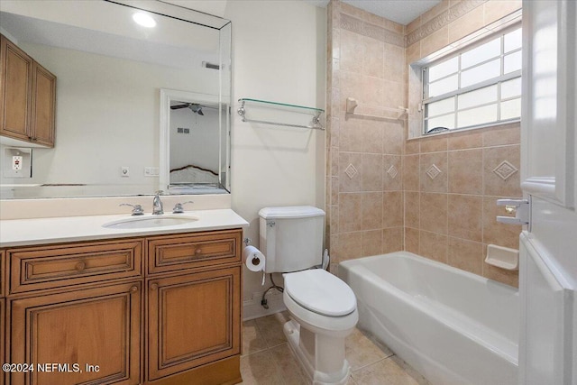 full bathroom with tile patterned flooring, vanity, toilet, and tiled shower / bath