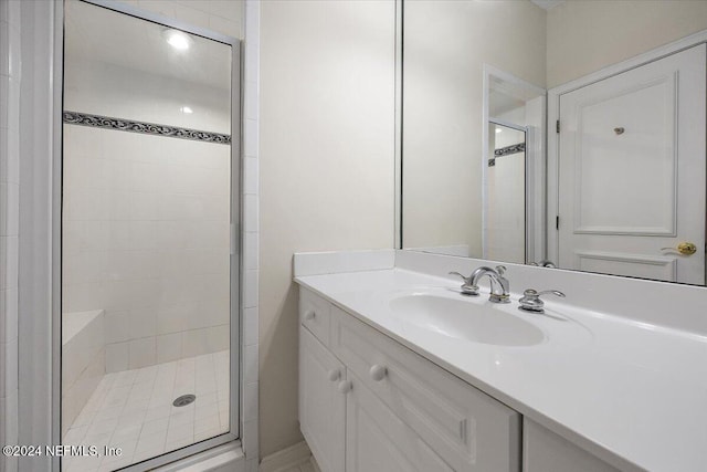 bathroom featuring vanity and a shower with shower door