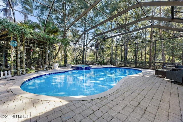 view of swimming pool featuring an in ground hot tub, glass enclosure, and a patio area