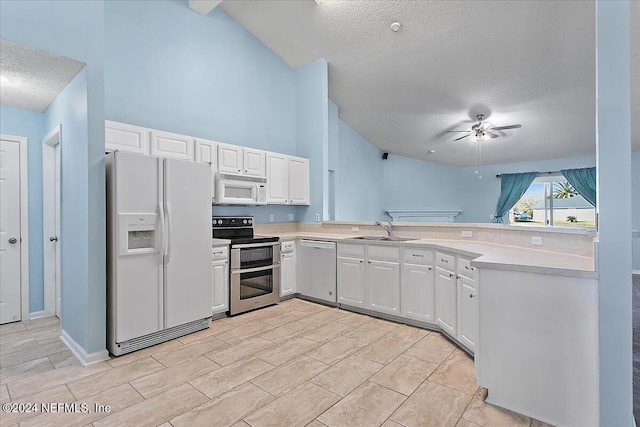 kitchen with white cabinets, a textured ceiling, stainless steel appliances, and sink