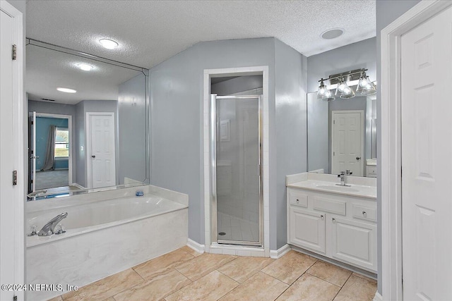 bathroom with tile patterned floors, vanity, a textured ceiling, and plus walk in shower