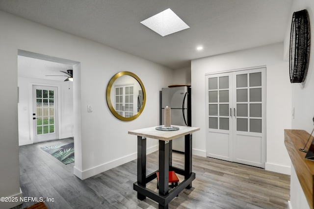 2149 Inwood Ter, Jacksonville, FL 32207 - interior space featuring a ceiling fan, recessed lighting, a skylight, wood finished floors, and baseboards