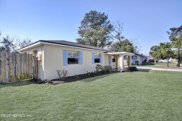 single story home with fence, a front lawn, and stucco siding