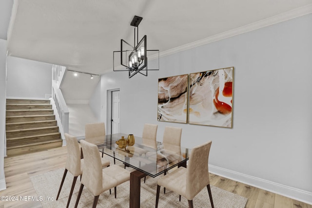 dining room featuring light hardwood / wood-style floors and ornamental molding