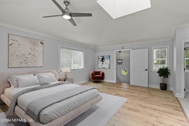 bedroom with ceiling fan, light wood-type flooring, ornamental molding, and multiple windows