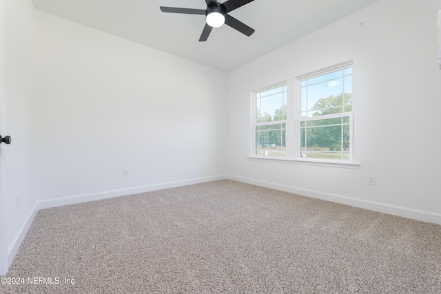 spare room with carpet floors and ceiling fan