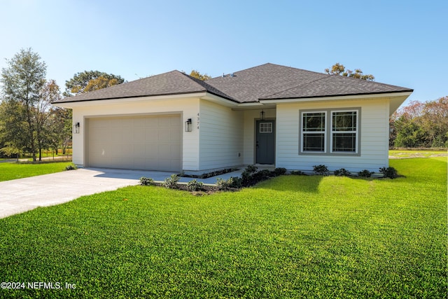 view of front of home featuring a garage and a front lawn