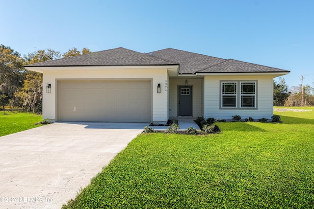 view of front facade with a front yard and a garage