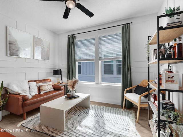 living room featuring hardwood / wood-style floors and ceiling fan