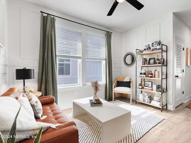 living room featuring ceiling fan and light wood-type flooring