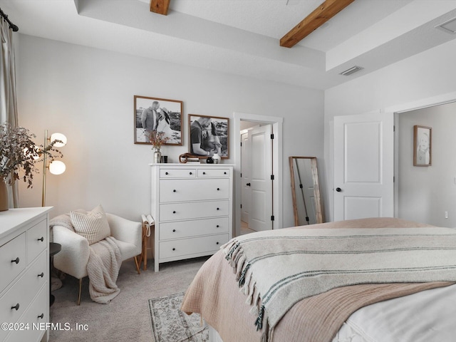 bedroom with beamed ceiling and carpet