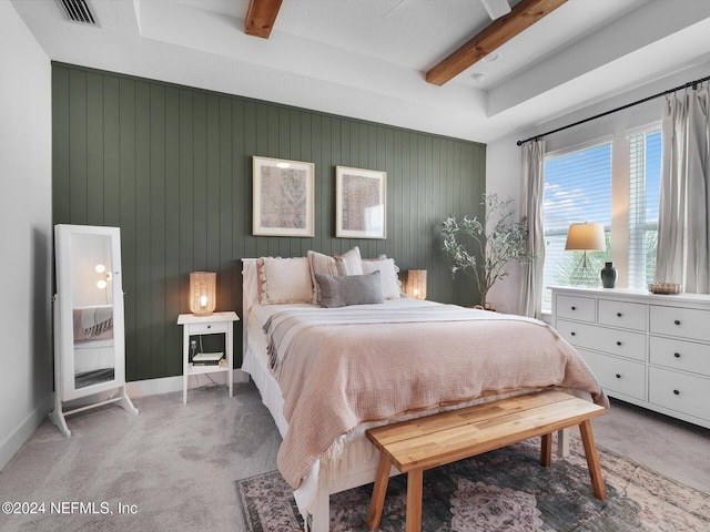 carpeted bedroom featuring beamed ceiling and wood walls