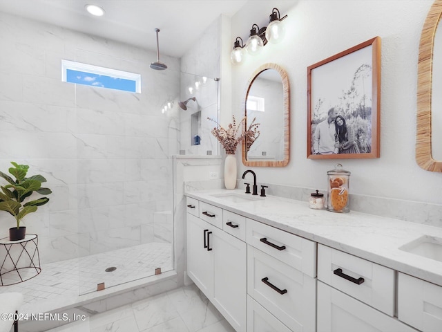 bathroom featuring a tile shower and vanity